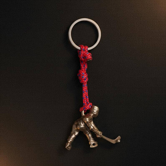 Llavero metálico importado con figura de bronce con el diseño de jugador de hockey